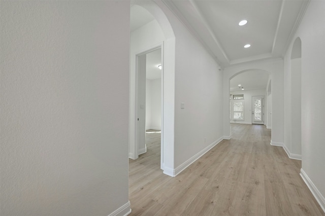 hall with crown molding and light hardwood / wood-style floors