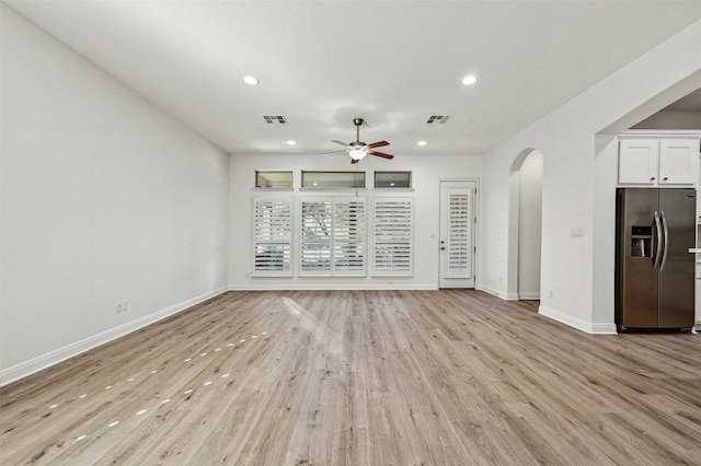 unfurnished living room featuring ceiling fan and light wood-type flooring