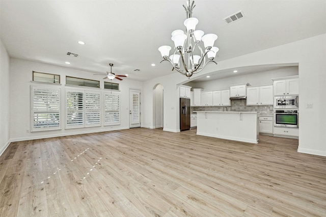 unfurnished living room with ceiling fan with notable chandelier and light hardwood / wood-style flooring