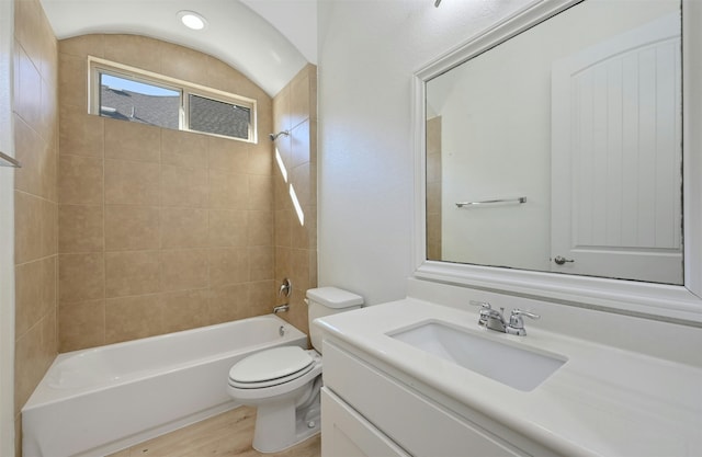 full bathroom with vanity, hardwood / wood-style floors, tiled shower / bath combo, and toilet