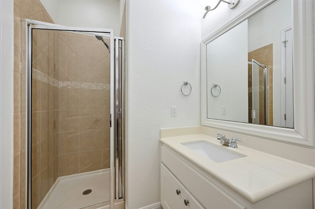 bathroom featuring vanity and a shower with door