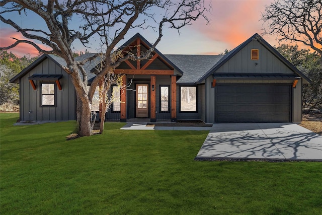 view of front of house with a yard and a garage