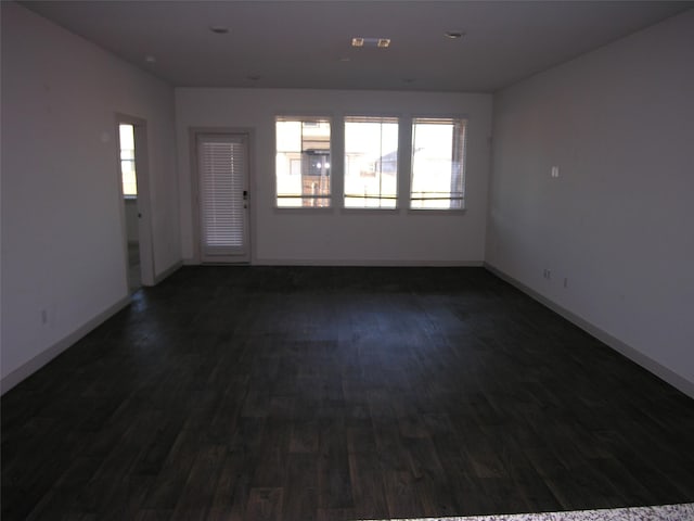 spare room with dark wood-type flooring