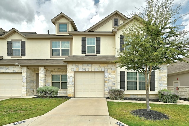 view of property featuring a garage and a front yard