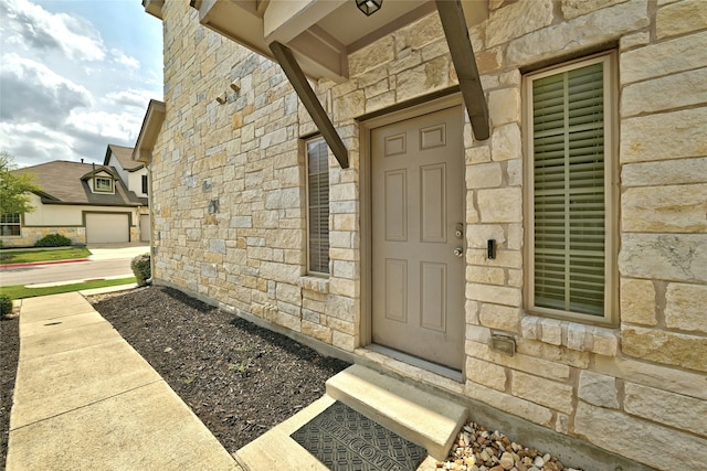 view of exterior entry featuring a garage