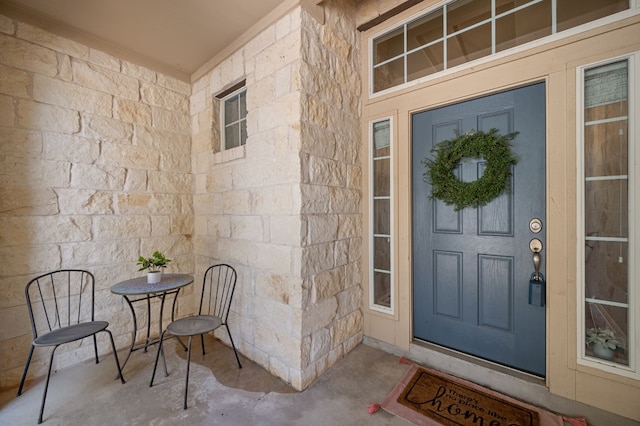 doorway to property with stone siding