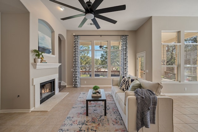 living room with light tile patterned floors and ceiling fan