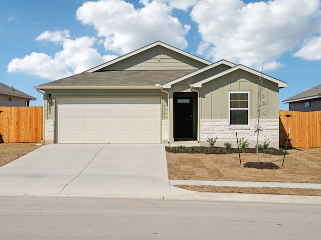 ranch-style house featuring driveway, a garage, fence, and board and batten siding