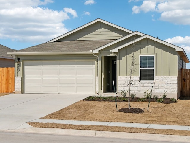 ranch-style house featuring board and batten siding, fence, a garage, stone siding, and driveway