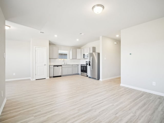 kitchen featuring open floor plan, light countertops, and appliances with stainless steel finishes