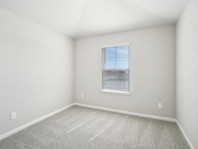 unfurnished room with carpet and baseboards