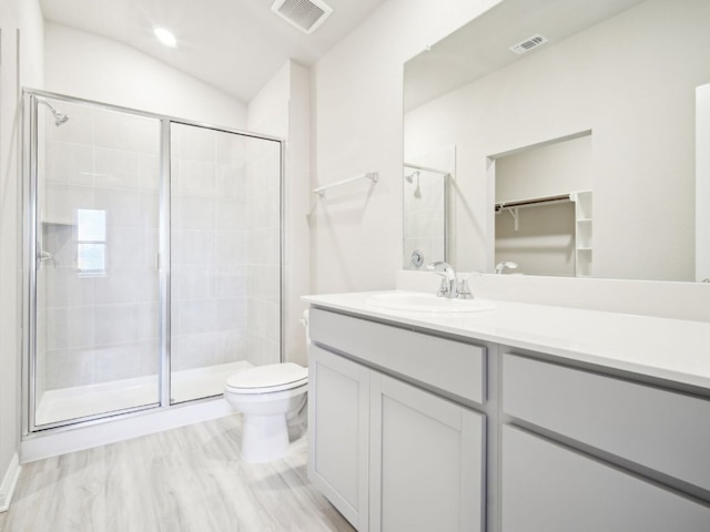 full bathroom featuring toilet, a stall shower, and visible vents