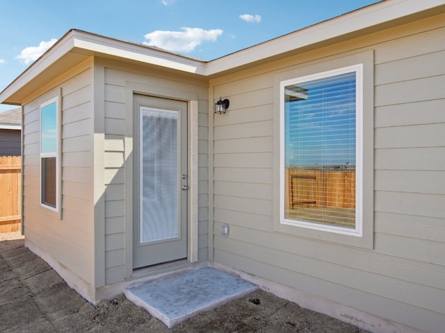 view of exterior entry with fence