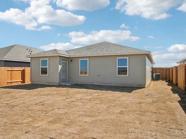 back of house with cooling unit and a fenced backyard