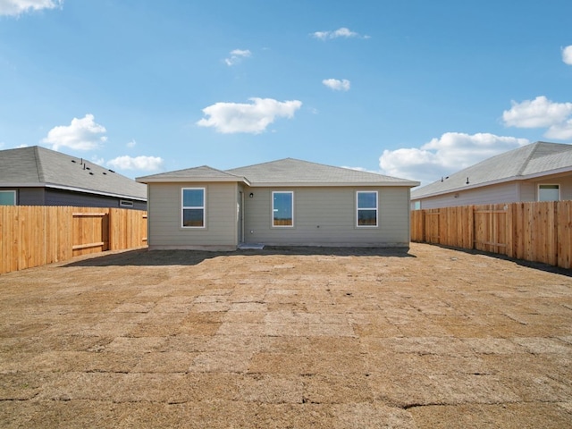 back of house featuring a fenced backyard