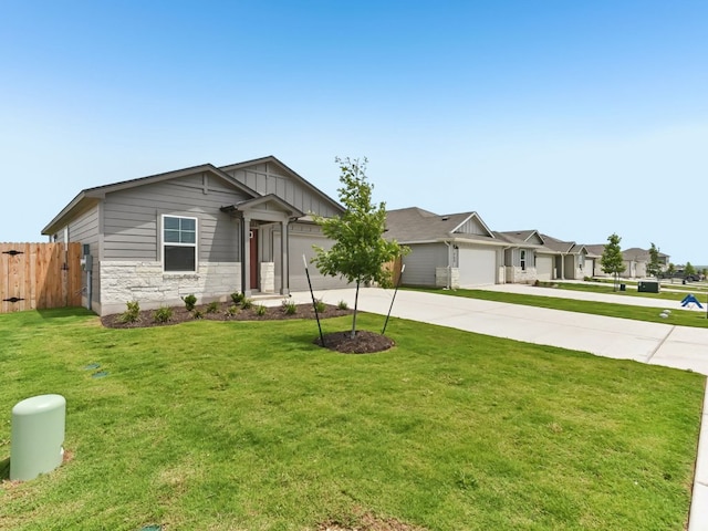249 Boatright Blvd, Jarrell, TX 76537 - view of front of house featuring driveway, a garage, board and batten siding, and stone siding