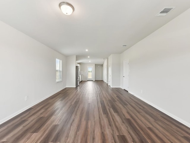 249 Boatright Blvd, Jarrell, TX 76537 - unfurnished living room featuring baseboards, dark wood-style flooring, and recessed lighting
