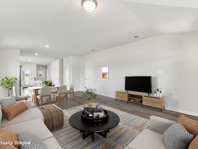 249 Boatright Blvd, Jarrell, TX 76537 - living room featuring wood finished floors, baseboards, recessed lighting, and lofted ceiling