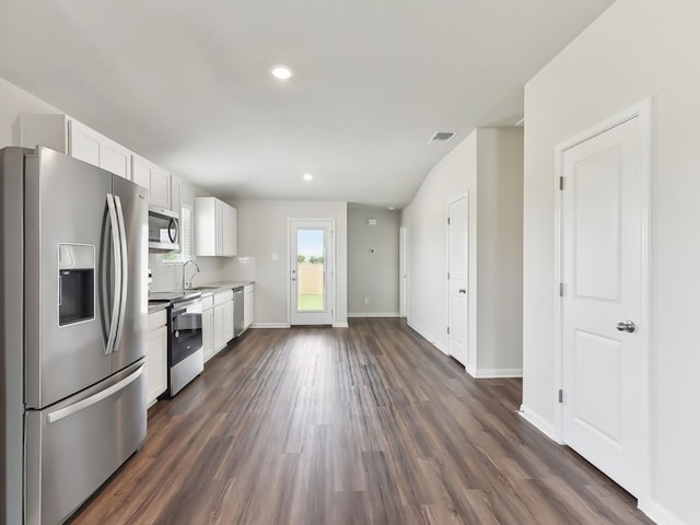 249 Boatright Blvd, Jarrell, TX 76537 - kitchen featuring appliances with stainless steel finishes, white cabinets, dark wood-type flooring, baseboards, and recessed lighting