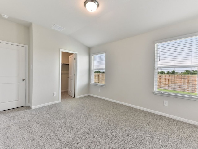 249 Boatright Blvd, Jarrell, TX 76537 - unfurnished bedroom with carpet floors, baseboards, vaulted ceiling, a spacious closet, and a closet