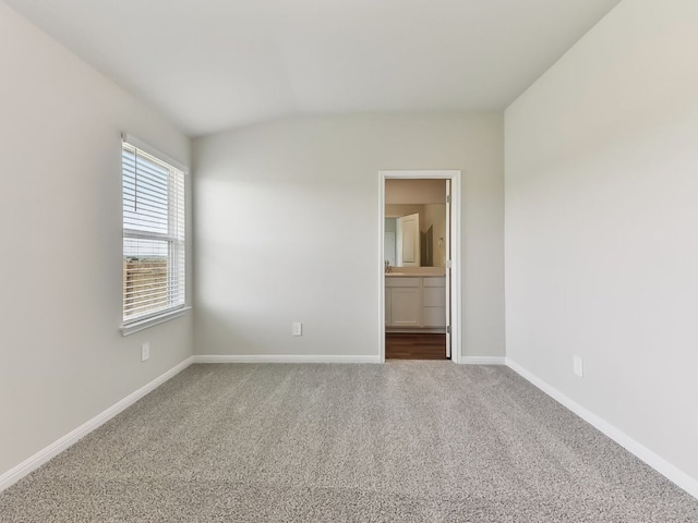 249 Boatright Blvd, Jarrell, TX 76537 - unfurnished bedroom with carpet floors, baseboards, lofted ceiling, and ensuite bath