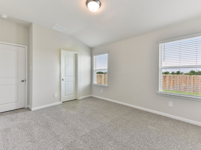 249 Boatright Blvd, Jarrell, TX 76537 - unfurnished bedroom with multiple windows, carpet, vaulted ceiling, and baseboards