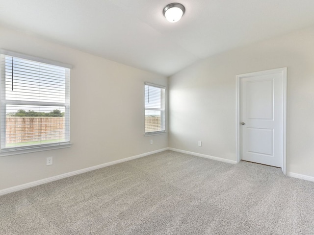 249 Boatright Blvd, Jarrell, TX 76537 - spare room with light colored carpet, baseboards, and vaulted ceiling