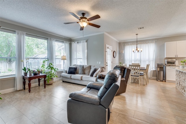 living room with ceiling fan with notable chandelier, plenty of natural light, ornamental molding, and a textured ceiling