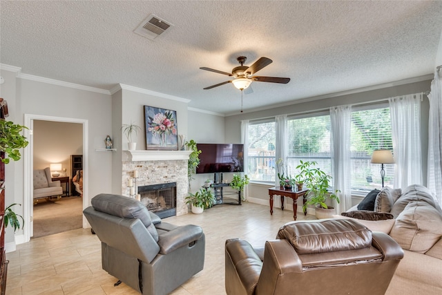 living room with a fireplace, ornamental molding, light colored carpet, ceiling fan, and a textured ceiling