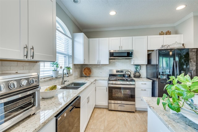 kitchen with white cabinets, decorative backsplash, and black appliances