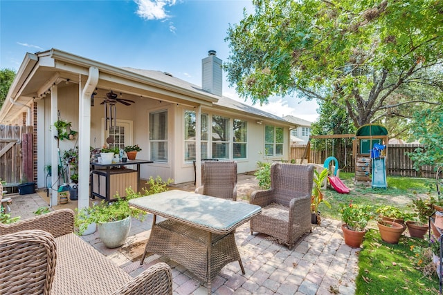 view of patio / terrace featuring ceiling fan and a playground