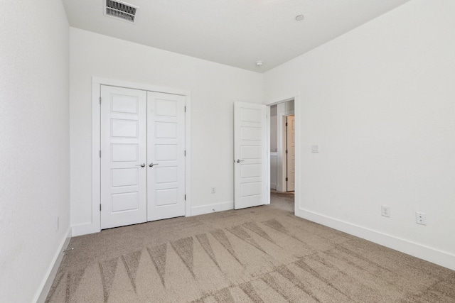 unfurnished bedroom with a closet and carpet