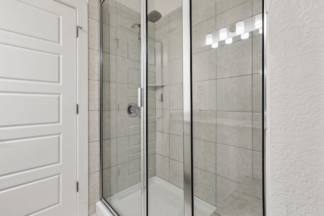 bathroom with a shower with door