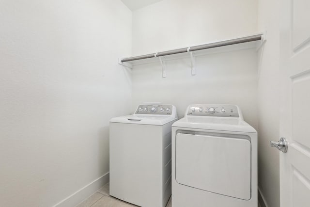 laundry area featuring light tile patterned floors and washing machine and clothes dryer