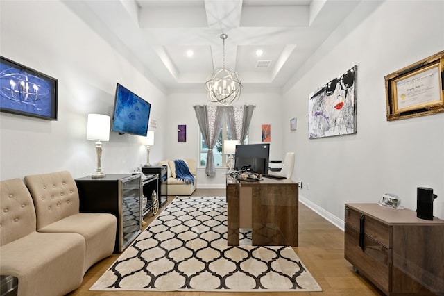 office with baseboards, visible vents, coffered ceiling, wood finished floors, and an inviting chandelier