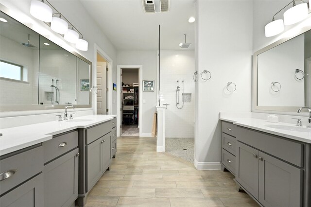 bathroom featuring vanity and a tile shower