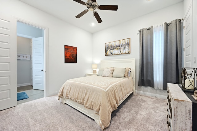 bedroom with light carpet and ceiling fan