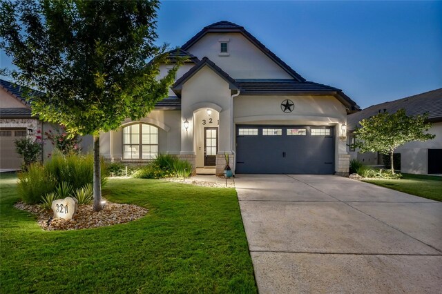 view of front facade featuring a garage and a front lawn