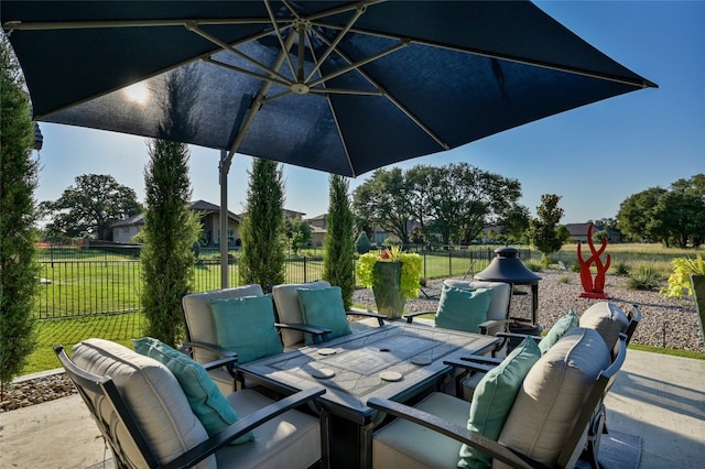 view of patio featuring outdoor dining area and fence