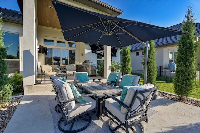 view of patio featuring outdoor lounge area, exterior kitchen, outdoor dining space, and fence