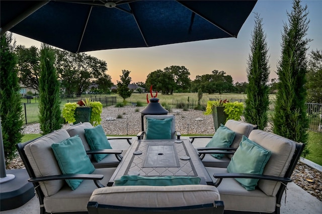 patio terrace at dusk featuring outdoor lounge area