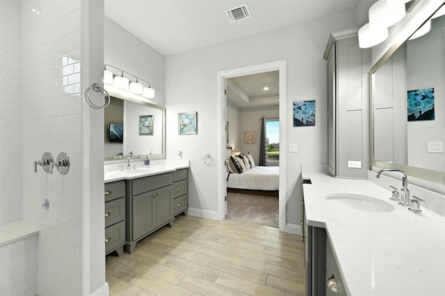 bathroom with vanity and a shower