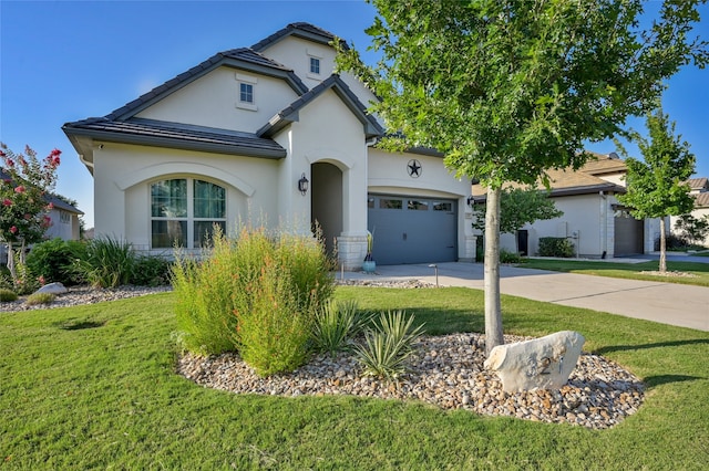 view of front of house with a garage and a front yard