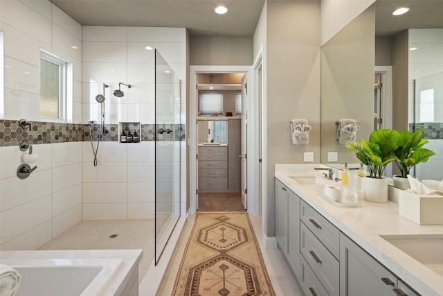 bathroom featuring tile patterned flooring, vanity, and separate shower and tub