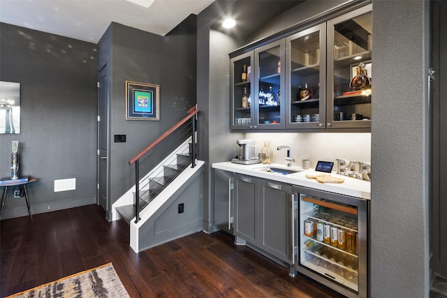 bar with gray cabinets, sink, wine cooler, and dark hardwood / wood-style floors