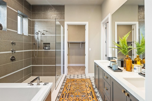 bathroom featuring independent shower and bath, vanity, and tile patterned flooring