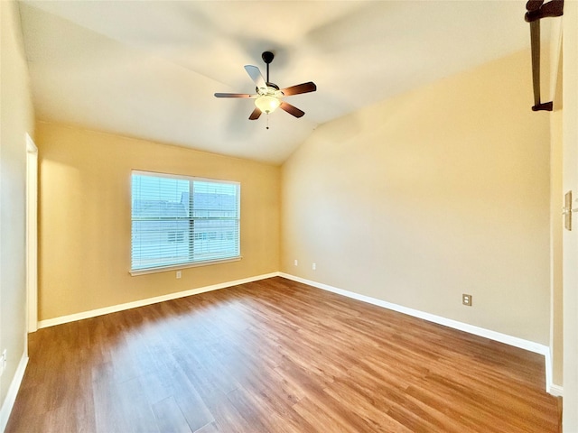 spare room featuring lofted ceiling, hardwood / wood-style floors, and ceiling fan