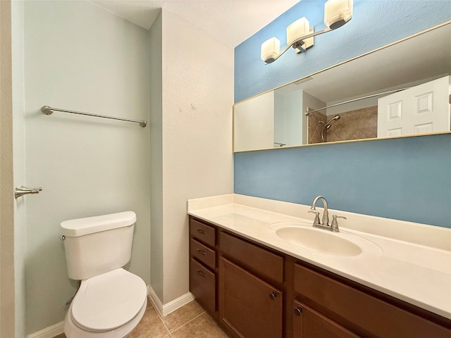 bathroom featuring vanity, tile patterned floors, and toilet