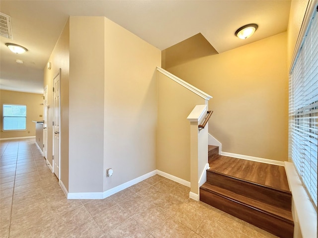 stairway with tile patterned floors