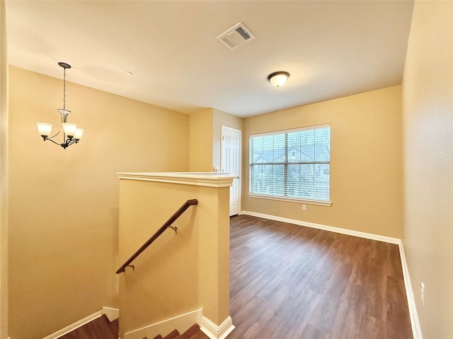 interior space with a notable chandelier and hardwood / wood-style flooring